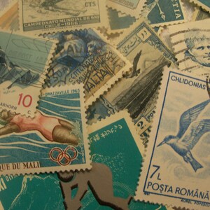 May include: A collection of vintage postage stamps with various designs and colors. Stamps feature images of athletes, mountains, birds, and historical figures. Some stamps have text in multiple languages, including English, French, and German.