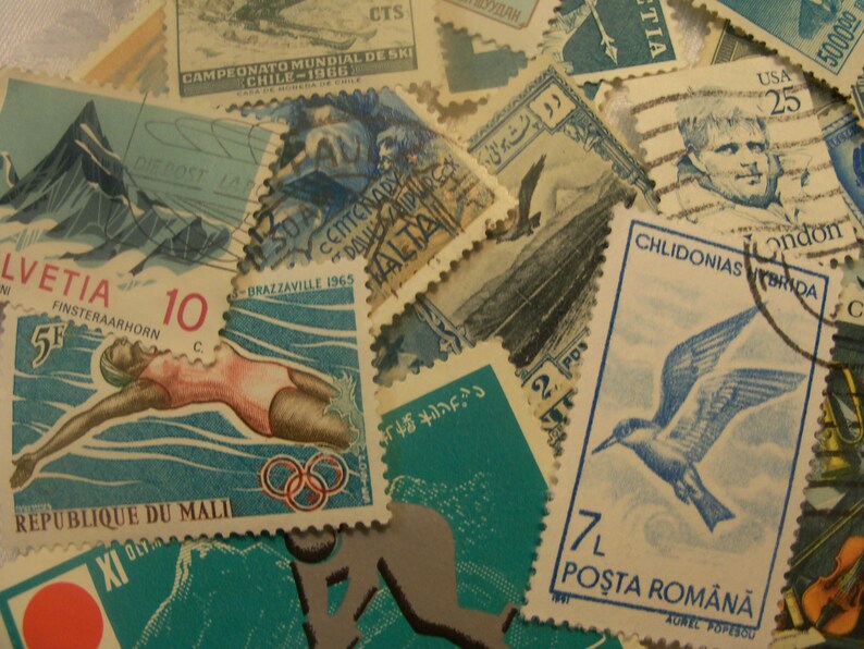 May include: A collection of vintage postage stamps with various designs and colors. Stamps feature images of athletes, mountains, birds, and historical figures. Some stamps have text in multiple languages, including English, French, and German.