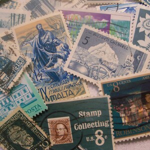 May include: A collection of vintage postage stamps with various designs and colors. Stamps feature images of historical figures, landscapes, and text, including "Stamp Collecting" and "U.S. 8 Cents."