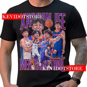 May include: Black t-shirt featuring a collage of images of a basketball player, with the name "Xavian Lee" in purple and orange text. The shirt also has the text "MEMDA BASKETBALL" and "KEVIDOTSTORE".