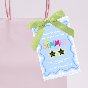 May include: A blue and white checkered gift tag with a summer theme. The tag has a sun with a smiley face, the word "SUMMER" in rainbow letters, and sunglasses with stars. The text reads "Have so much fun in the sun this SUMMER. Thank you for a great year in PK3! Mrs. Ball & Mrs. Howard."