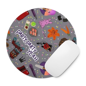 May include: Round gray mousepad with a colorful pattern of food, musical instruments, and a pink bunny. The text "PARTY, PARTY, YEAH" is printed on the mousepad. A white computer mouse is on the right side of the mousepad.