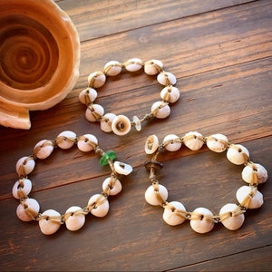 Comfortable flat laced puka shell bracelet with seaglass locking clasp