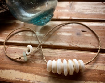 Classic 7 white puka stacker necklace with tiny white puka spacers