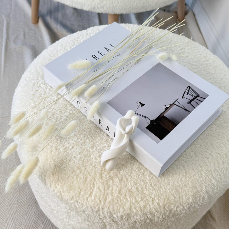 3D printed abstract couple statue with a white finish, placed in a cozy living room setting. adding a romantic touch to home decor.