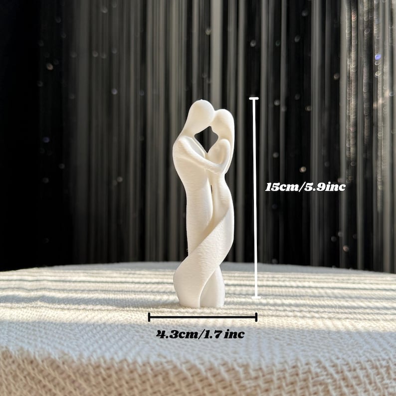 Close-up of the 3D printed white couple statue, highlighting the abstract intertwined design of two lovers in a romantic embrace, 15cm in height.