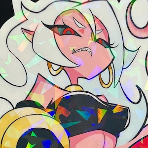 May include: Holographic sticker of an anime-style character with white hair, red eyes, and pink skin. The character is wearing a black top and gold jewellery. The sticker has a pink and red flame design and the text "VELVETRED".