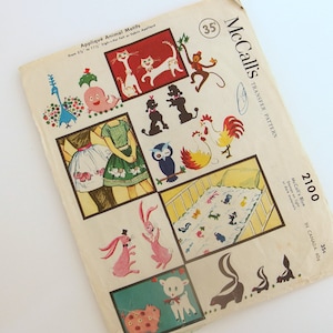 May include: McCall's Transfer Pattern 2100, Applique Animal Motifs, 35p. A vintage sewing pattern featuring a variety of animal motifs, including a rooster, a peacock, a rabbit, a skunk, a cat, a monkey, a dog, an owl, and a pig. The pattern is designed for use on fabric and includes instructions for applique.