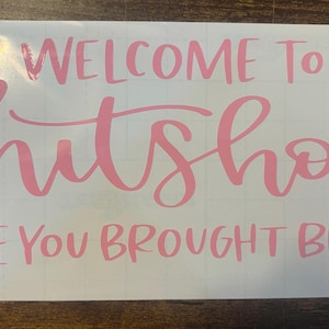May include: Pink vinyl decal with the text "Welcome to the Shitshow [Hope you brought beer]" on a white background.