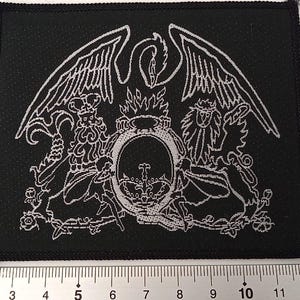 May include: Black and white embroidered patch featuring the Queen crest with a phoenix and lion design.