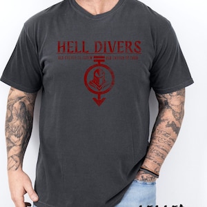 May include: A dark gray t-shirt with a red graphic print that says "Hell Divers" and "Old enough to screw, old enough to die".