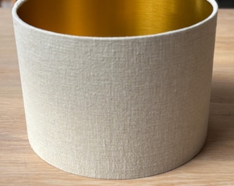 Luxury lampshade with a beautiful brushed-metal gold interior and light beige/sandy linen exterior