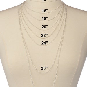 May include: A silver chain necklace displayed on a mannequin, showing different lengths from 14 inches to 36 inches.