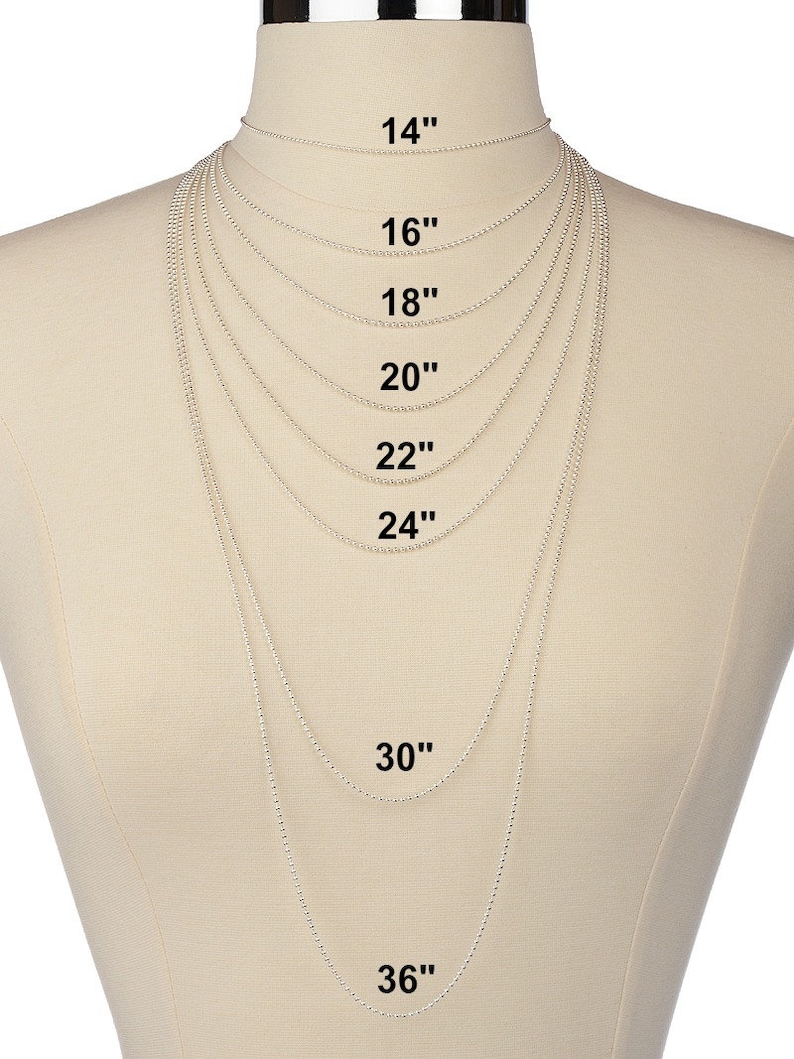 May include: A silver chain necklace displayed on a mannequin, showing different lengths from 14 inches to 36 inches.