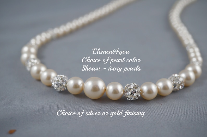 May include: A pearl necklace with ivory pearls and crystal accents. The necklace is available in silver or gold finishes. "Element4you Choice of pearl color Shown - ivory pearls Choice of silver or gold finishing"