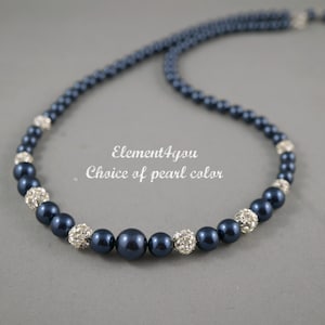 May include: A navy blue pearl necklace with silver rhinestone accents. The necklace is made of round pearls and silver beads with rhinestones.