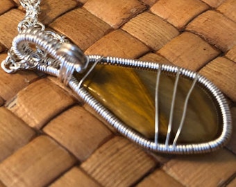 Wire wrapped polished stone pendant, Tiger's Eye and Non-tarnish Silver plated wire.