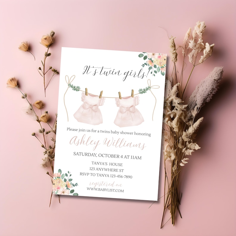 May include: A baby shower invitation with the text "It's twin girls!" features two pink dresses hanging on a clothesline. The invitation includes details for Ashley Williams' baby shower, with floral accents and a pink background.