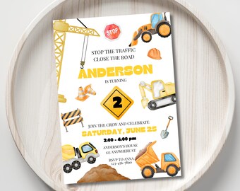 May include: Construction themed birthday party invitation with a yellow and black color scheme. The invitation features a watercolor illustration of construction vehicles, including a crane, excavator, dump truck, and bulldozer. The text on the invitation reads "Stop the traffic, close the road, Anderson is turning 2. Join the crew and celebrate Saturday, June 25, 2:00-4:00 pm, Anderson's House, 123 Anywhere St, RSVP to Anna 123-456-7890."
