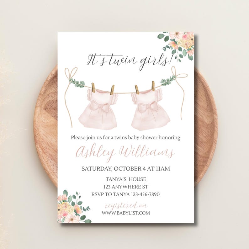 May include: A baby shower invitation with the text "It's twin girls!" shows two pink dresses hanging on a washing line. The invitation includes details for Ashley Williams' baby shower, including the date, time, and location.