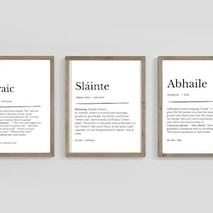 May include: Three framed prints with Irish words and their definitions. The central print displays "Sl&aacute;inte", meaning "Health/Cheers", with its pronunciation. The other prints show "Craic" and "Abhaile", all in a simple, minimalist style.