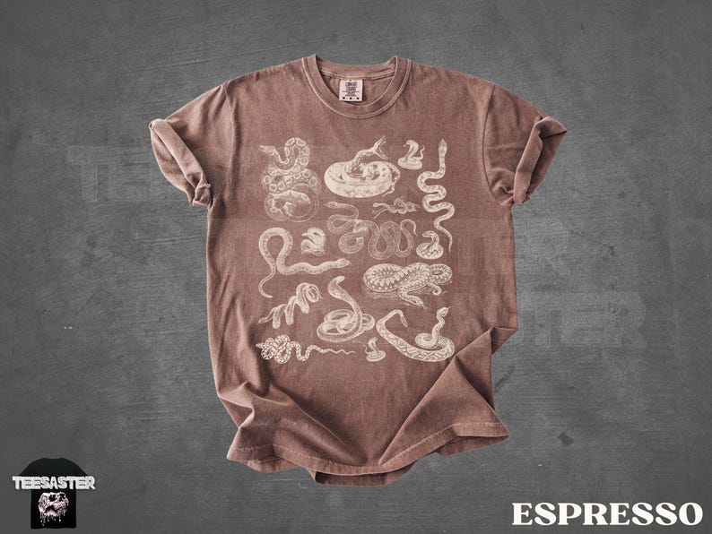 May include: Espresso-coloured t-shirt with white snake illustrations. The design includes various snake species. The shirt has a crew neck and short sleeves. The word "ESPRESSO" is printed in white at the bottom right.