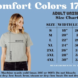 May include: A woman wearing a sage green t-shirt with a size chart for adult unisex t-shirts. The chart lists sizes S to 4XL with width and length measurements in inches. The text "Comfort Colors 1717" is at the top.