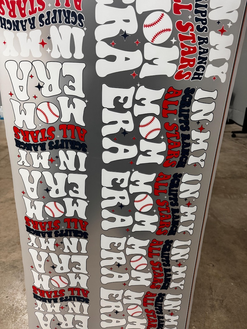 May include: A gray baseball-themed design with the words "In My Mom Era" and "All Stars" in white, red, and navy blue. Baseball graphics are also included. The text "Scripps Ranch" is also present.