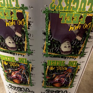 May include: A white surface with multiple images featuring horror movie characters and text. The text includes "Do you feel lucky?" and "Kiss me, I'm Irish". The images are framed with gold and green glitter.