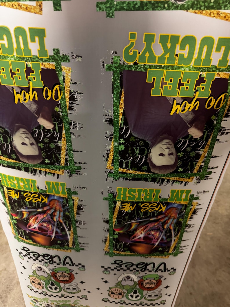 May include: A white surface with multiple images featuring horror movie characters and text. The text includes "Do you feel lucky?" and "Kiss me, I'm Irish". The images are framed with gold and green glitter.