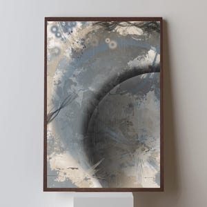 May include: Abstract art print in a dark brown frame. The artwork features a blend of gray, blue, and beige tones with circular and linear elements. The overall composition has a textured, layered appearance, creating depth and visual interest.