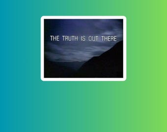 May include: A sticker with a gradient green and blue background. The sticker has a white border and features a dark image of a mountain range under a cloudy sky. The text "THE TRUTH IS OUT THERE" is in white.