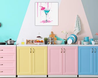 May include: A kitchen with colorful cabinets in pink, yellow, and blue. The cabinets have silver handles. A painting of a blue cocktail with a pink umbrella hangs on the wall above the cabinets.