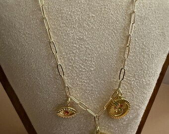 Moon, eye, and sun pendant necklace