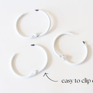 May include: Three white metal rings with a clip closure. The rings are easy to clip on and off.