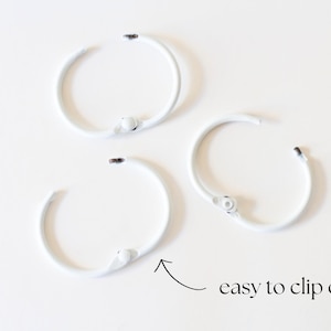 May include: Three white metal rings with a clip closure. The rings are easy to clip on and off.