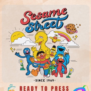 May include: A DTF transfer sheet featuring a colorful Sesame Street graphic with Big Bird, Ernie, Bert, Cookie Monster, Elmo, and Grover. The design includes a sun, rainbow, flowers, and a cookie planet with the text Sesame Street and SINCE 1969.