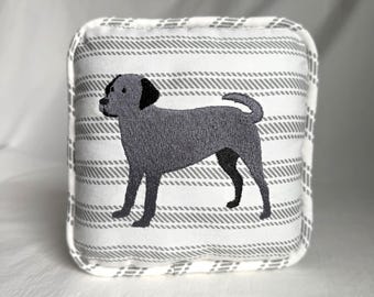 May include: A gray and white striped pillow with an embroidered gray dog silhouette.