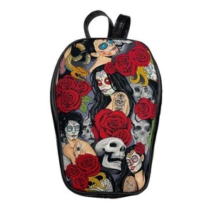 May include: Black leather backpack with a colorful print featuring skulls, roses, and women with sugar skull makeup.