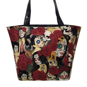 May include: A black tote bag with a colorful print of sugar skulls, roses, and women with intricate makeup.