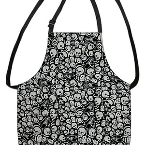 May include: Black apron with a white skull and crossbones pattern. The apron has adjustable straps.