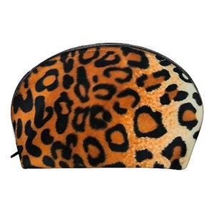 May include: A leopard print cosmetic bag. The bag has a rounded shape with a black zip and pull. The leopard print features black spots on a tan and orange background.