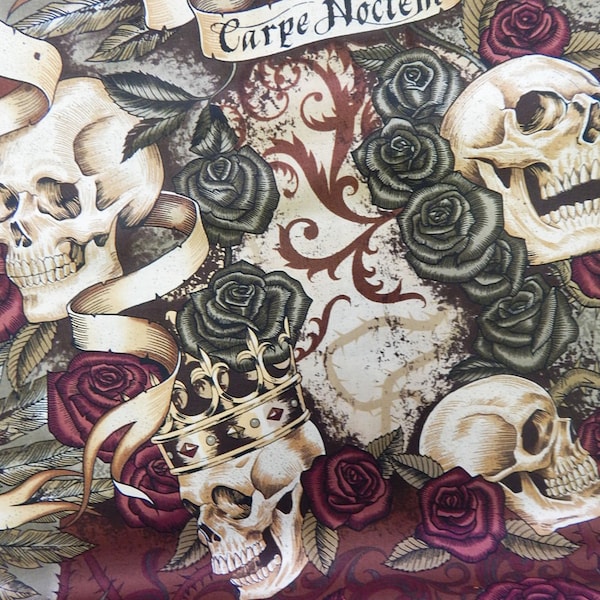 May include: A fabric print featuring multiple human skulls, deep red roses, and dark green leaves. One skull wears a gold crown with red accents. A beige ribbon banner across the top displays the black text Carpe Noctem. The background has ornate brown scrollwork.