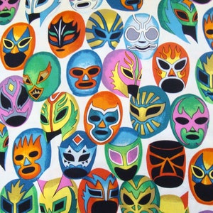 May include: A white fabric with a repeating pattern of colorful wrestling masks. The masks are in various styles and colors, including red, blue, green, yellow, and black.