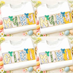 May include: White crew neck t-shirts with the words "MAMA", "NANA", "GIGI", and "MIMI" in colorful, floral, and patterned letters. Each word is framed with a decorative border and a bow.