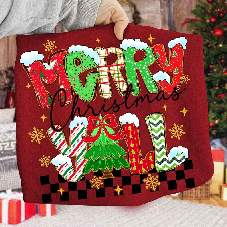 May include: A red Christmas-themed tote bag with the words "MERRY Christmas Y'ALL" in a festive, colorful design. The letters are decorated with patterns, snow, and a Christmas tree. Gold stars and snowflakes are scattered around the text.