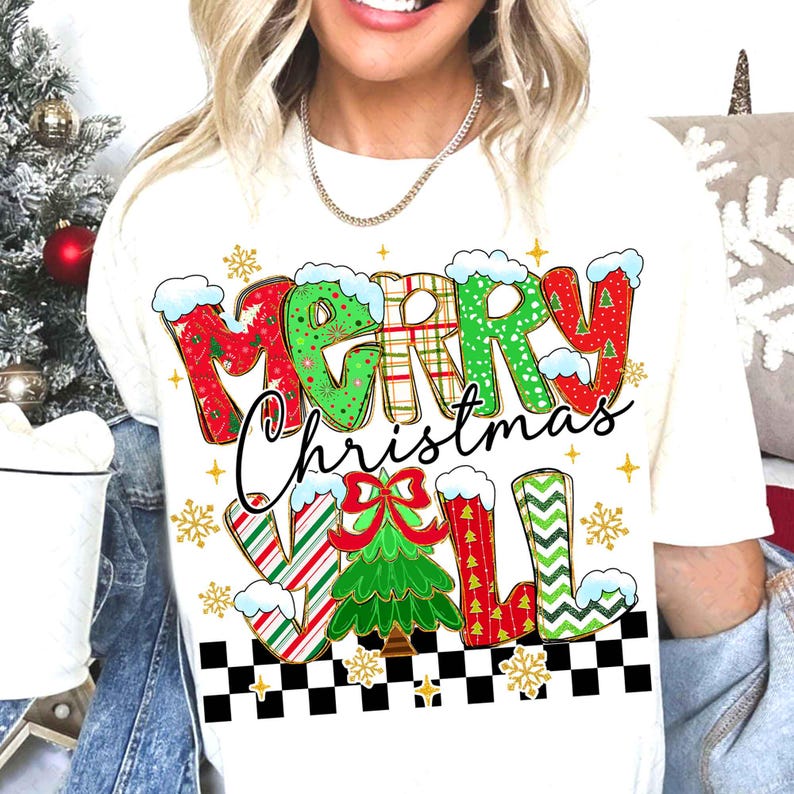 May include: Cream-colored t-shirt with a festive "Merry Christmas Y'all" graphic. The text features red, green, and white patterns with snow accents. A Christmas tree and snowflakes complete the holiday design.