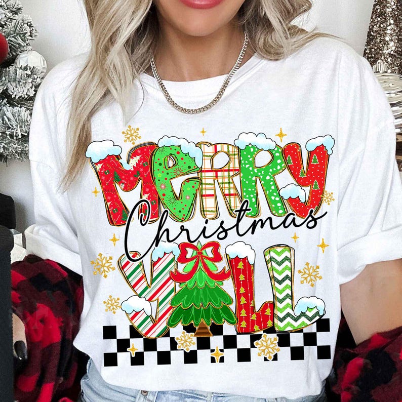 May include: White t-shirt with a festive "MERRY Christmas Y'ALL" design. The text features a mix of red, green, and plaid patterns, with snowflakes and a Christmas tree graphic. The shirt has a black and white checkered border.