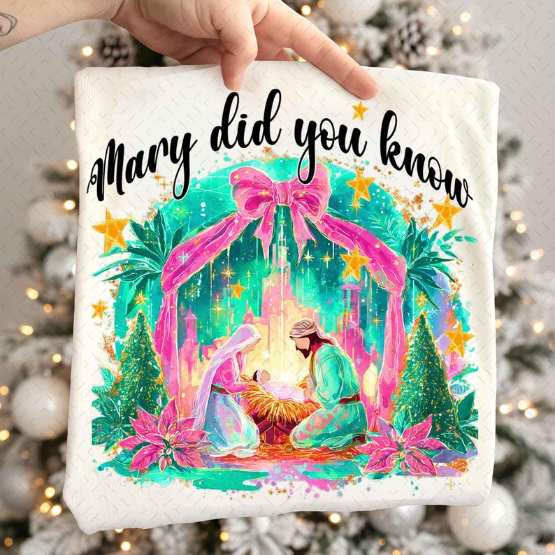 May include: White t-shirt with a colorful graphic of the Nativity scene, featuring Mary, Joseph, and baby Jesus. The text "Mary did you know" is written in black script above the image, with pink and gold accents.