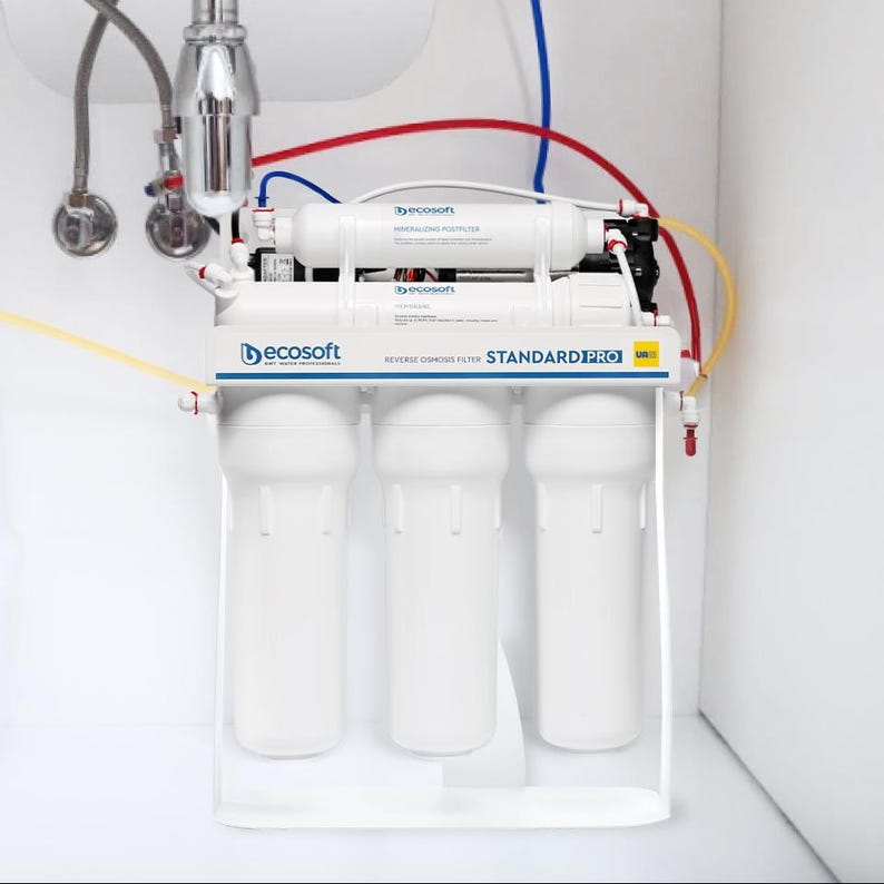 May include: A white reverse osmosis water filtration system with four filters. The system has a blue and red label that reads "STANDARD PRO" and "REVERSE OSMOSIS FILTER".